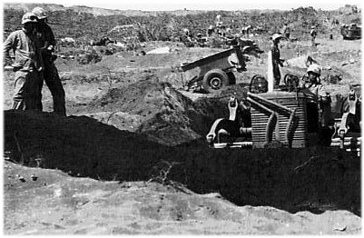 USMC Official Photo - HQ#11649; Bulldozer scoops out excavation for telephone exchange just behind front lines.